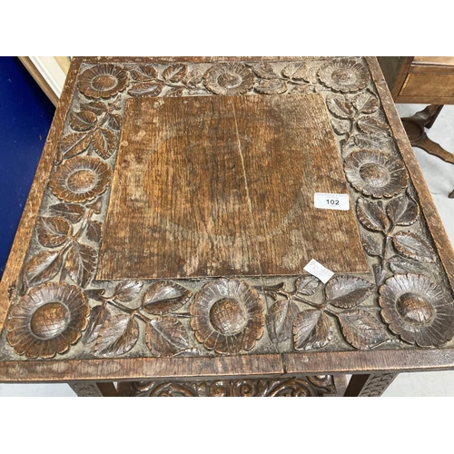 102 - 20th cent. Oak arts and crafts table carved floral relief the top opening to reveal storage. 18ins. ... 