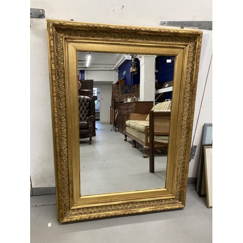 125 - 20th cent. Gilt mirror with moulded gesso frame. 47¼ins. x 35½ins.