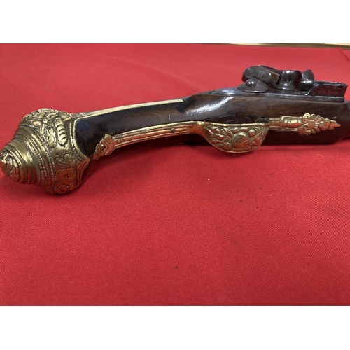 245 - 18th cent. Turkish flintlock with brass decorated lock plate and pommel. 20ins.