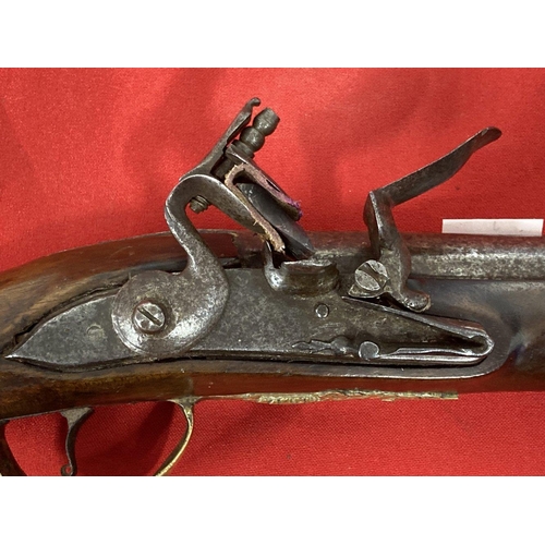 245 - 18th cent. Turkish flintlock with brass decorated lock plate and pommel. 20ins.