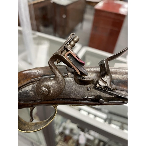 245 - 18th cent. Turkish flintlock with brass decorated lock plate and pommel. 20ins.