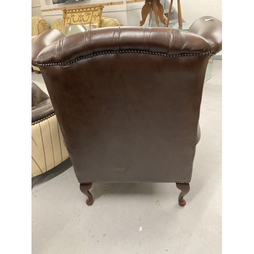 28A - 20th cent. Thomas Lloyd brown leather wing armchair with Chesterfield style back.