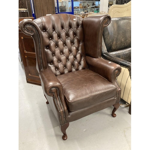 28A - 20th cent. Thomas Lloyd brown leather wing armchair with Chesterfield style back.