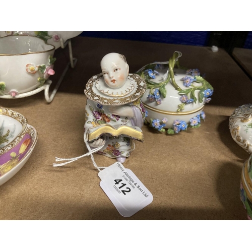 412 - Early 20th cent. German porcelain figural inkwell, Chinese boy reading a book dressed in a white flo... 