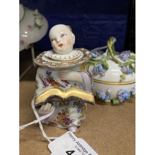 412 - Early 20th cent. German porcelain figural inkwell, Chinese boy reading a book dressed in a white flo... 