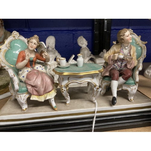 414 - Ceramics: German Volkstedt figural group - man and woman taking tea, decorated in coloured enamels w... 