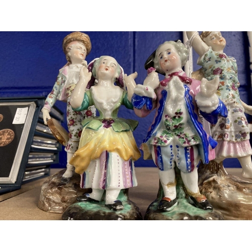 418 - Schierholz Figurines: Young girl and boy decorated in coloured enamels, he's holding a tambourine an... 