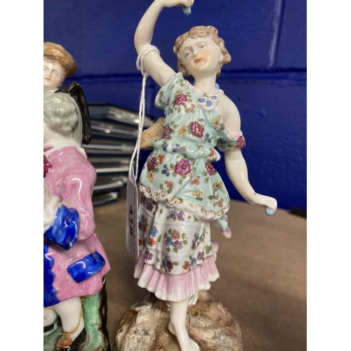 418 - Schierholz Figurines: Young girl and boy decorated in coloured enamels, he's holding a tambourine an... 