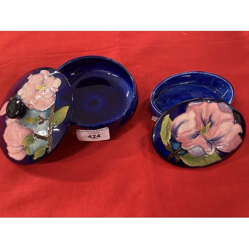 424 - Moorcroft 'Magnolia' pattern boxes each decorated with blossoming magnolias on a blue ground, impres... 