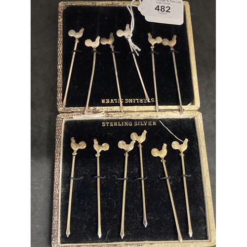 482 - Sterling Silver: Cocktail sticks, six silver and six silver gilt, all terminated with a figure of a ... 