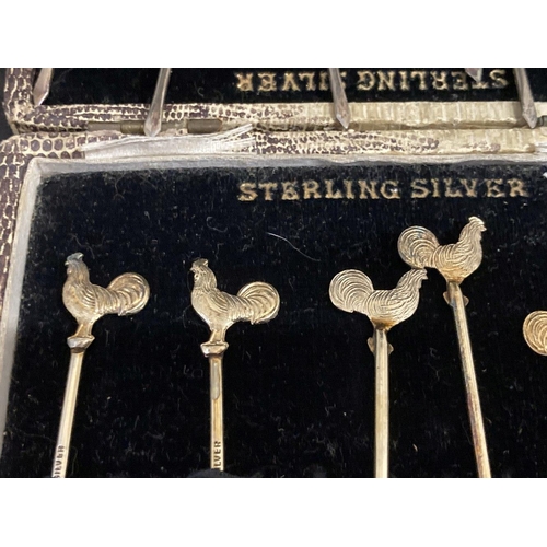 482 - Sterling Silver: Cocktail sticks, six silver and six silver gilt, all terminated with a figure of a ... 