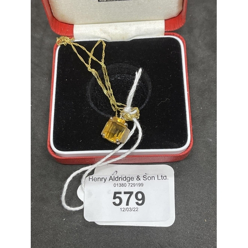 579 - Jewellery: Yellow metal necklet with a rectangular cut citrine pendant attached, estimated weight 2.... 