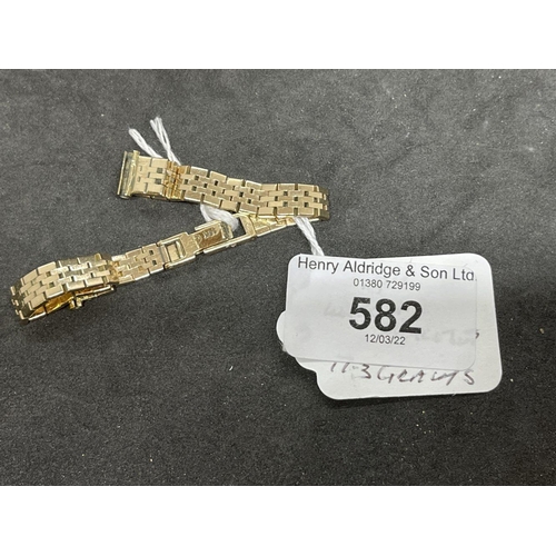 582 - Yellow metal brick link watch bracelet stamped 18K, tests as 18ct gold. Weight 17.3g.