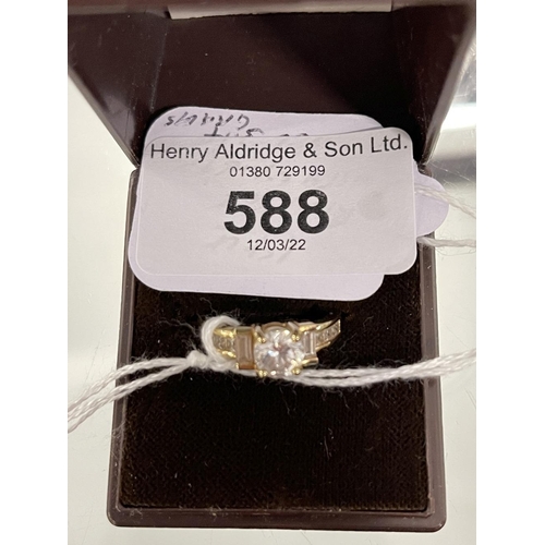 588 - Hallmarked Gold: 14ct gold ring set with a round and baguette cut white cubic zirconia hallmarked Bi... 