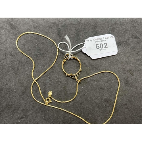 602 - Jewellery: Yellow metal chain tests as 18ct gold, length 20ins. with a coin mount attached tests as ... 