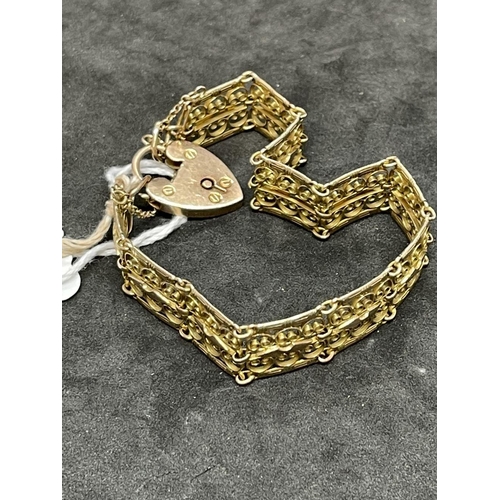 623 - Jewellery: Yellow metal fancy gate link bracelet with padlock fastener. Tests as 9ct gold, stamped 9... 