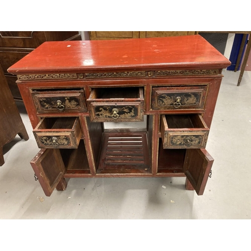 77 - Chinese: 20th cent. Red lacquer kneehole desk with black and gilt chinoiserie decoration. 39ins. x 1... 