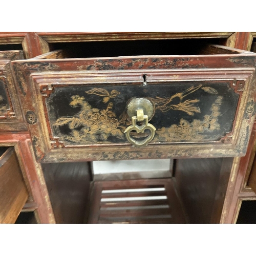 77 - Chinese: 20th cent. Red lacquer kneehole desk with black and gilt chinoiserie decoration. 39ins. x 1... 