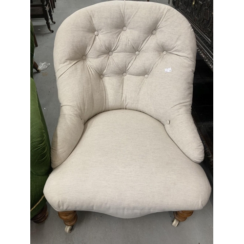 98 - Victorian button back upholstered armchair with turned legs on castors. Width 28ins. Depth 32ins. Pl... 