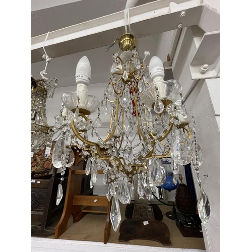 10 - 20th cent. Gilt chandeliers, the largest with six shaped branches, glass sconces and drops, 24ins dr... 