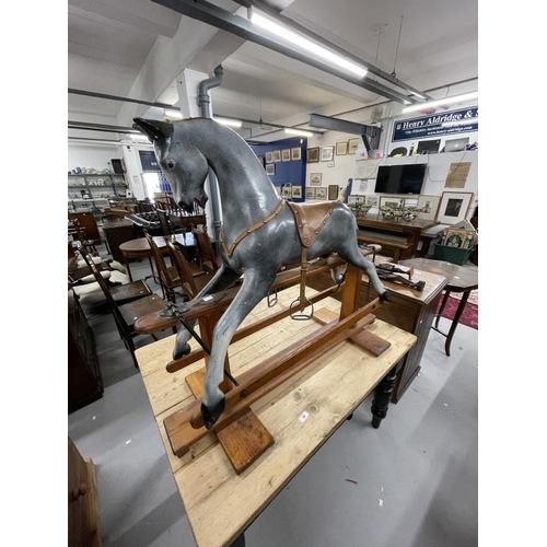 41 - 20th cent. Grey rocking horse with glass eyes, horsehair mane and tail on a pitch pine base. 44ins. ... 