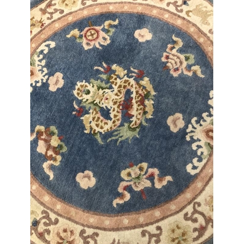 10 - Carpets & Rugs: Chinese hand washed circular rug, blue ground with a central panel depicting dragon ... 