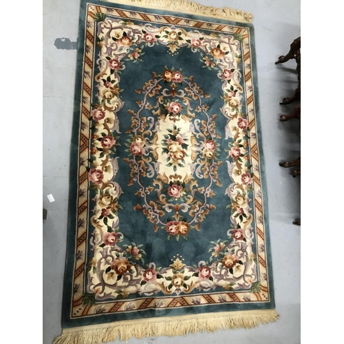 11 - Carpets & Rugs: Chinese hand washed green ground with floral decoration in pinks, browns, greens and... 
