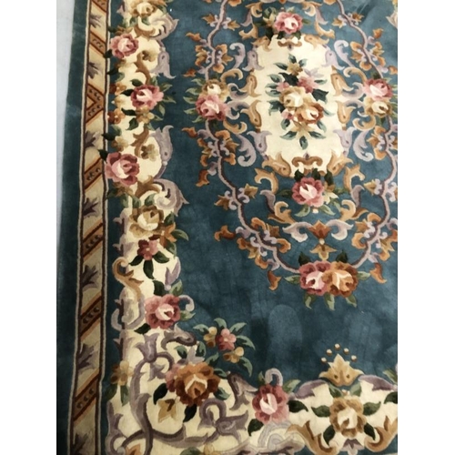 11 - Carpets & Rugs: Chinese hand washed green ground with floral decoration in pinks, browns, greens and... 