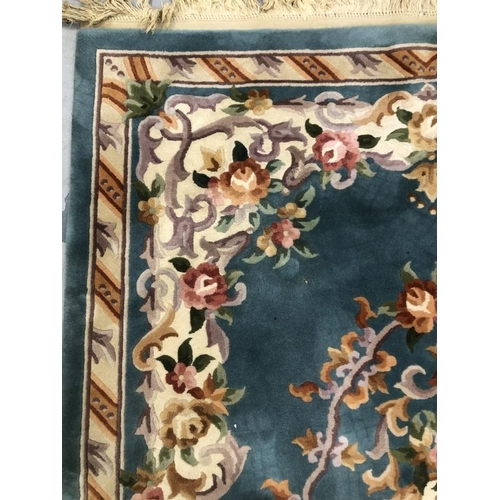 11 - Carpets & Rugs: Chinese hand washed green ground with floral decoration in pinks, browns, greens and... 