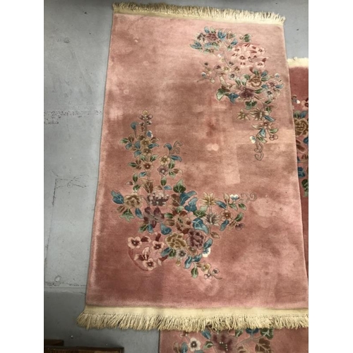 12 - Carpets & Rugs: Chinese hand wash pink ground with blues, reds, greens and browns, a pair. 98ins. x ... 
