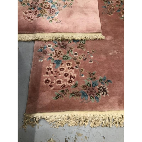 12 - Carpets & Rugs: Chinese hand wash pink ground with blues, reds, greens and browns, a pair. 98ins. x ... 