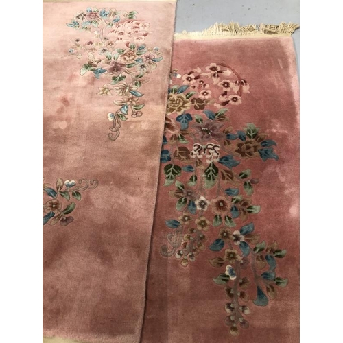 12 - Carpets & Rugs: Chinese hand wash pink ground with blues, reds, greens and browns, a pair. 98ins. x ... 
