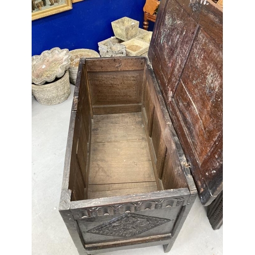 121 - 18th cent. Carved oak coffer with sunken two panel lid, original hinges, a three panel front with de... 