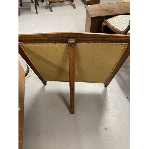 140 - Arts & Crafts: Oak fire screen with inset tapestry panel depicting peacocks.