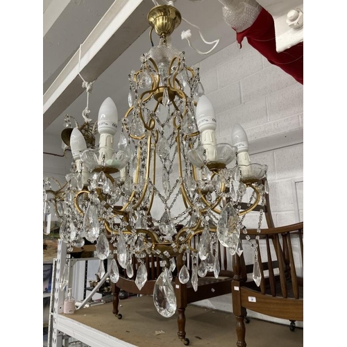 23 - 20th cent. Gilt chandeliers, the largest with six shaped branches, glass sconces and drops, 24ins dr... 