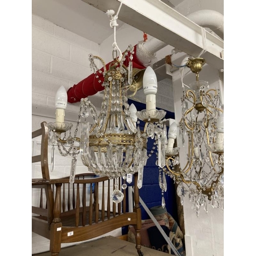 23 - 20th cent. Gilt chandeliers, the largest with six shaped branches, glass sconces and drops, 24ins dr... 