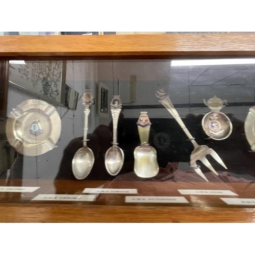 264 - Royal Navy/Militaria: A collection of enamel ships spoons and ashtrays most notably HMS Hood pickle ... 