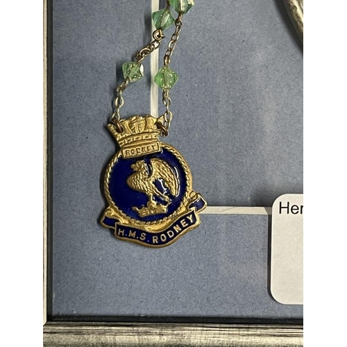 275 - Militaria/Royal Navy: H.M.S. Rodney sweetheart pendant, Vesta case and good luck horseshoe, framed. ... 