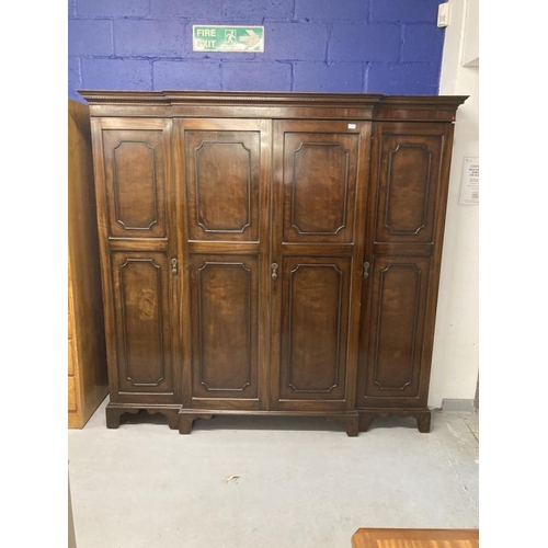 4 - 1920s mahogany break front wardrobe with castellated pelmet over four doors decorated with applied m... 