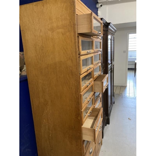 5 - Post-war haberdasher's shop display with sixteen glazed drawers above four others, all with chrome h... 