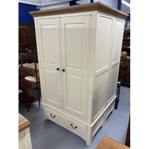 55 - 20th cent. Two door wardrobe with moulded oak cornice above two cream painted doors above a single d... 