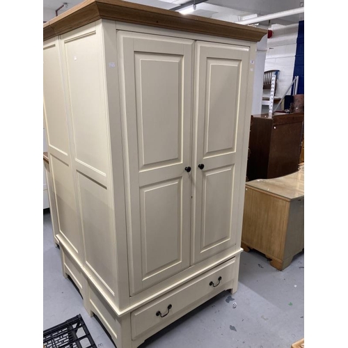 56 - 20th cent. Two door wardrobe with moulded oak cornice above two cream painted doors above a single d... 