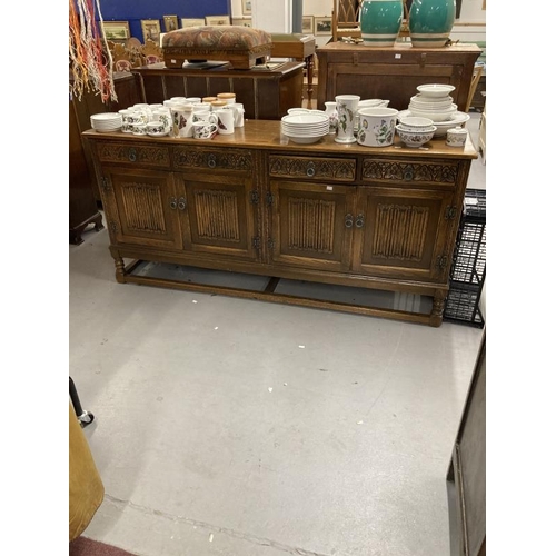 58 - 20th cent. Oak sideboard bears Old Charm furniture label, four short drawers with carved fronts abov... 