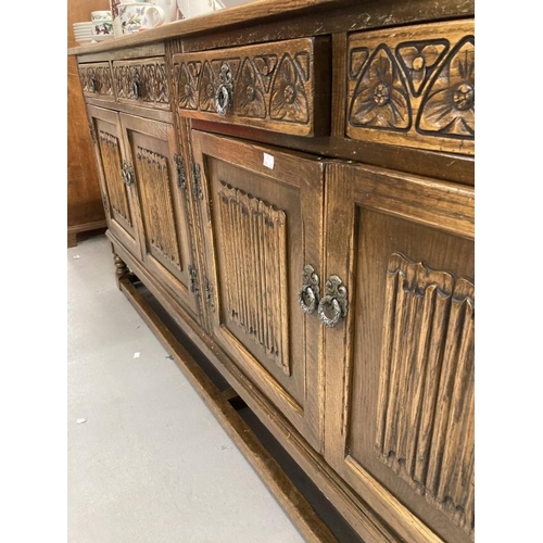 58 - 20th cent. Oak sideboard bears Old Charm furniture label, four short drawers with carved fronts abov... 