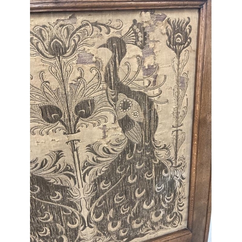 102 - Arts & Crafts: Oak fire screen with inset tapestry panel depicting peacocks.