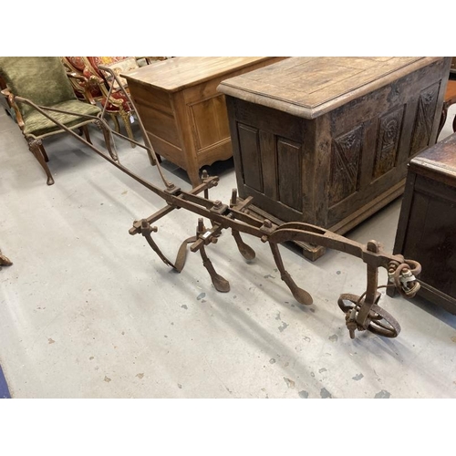 119 - Agricultural Antiques: Mid 19th cent. Horse drawn cast iron cultivator plough with directional wheel... 
