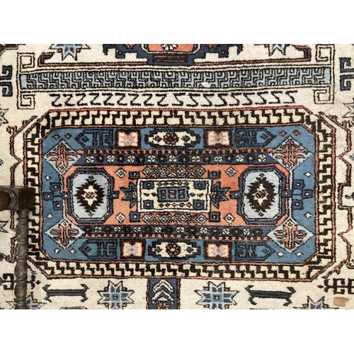 188 - Carpets & Rugs: 19th cent. Caucasian carpet possibly Kazak. Ivory ground with three rectangular pane... 