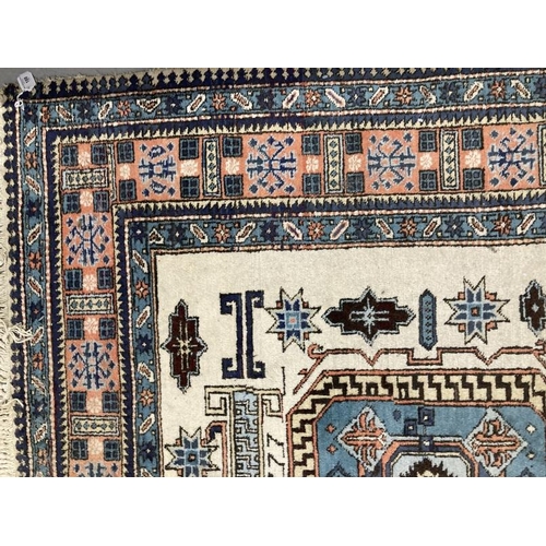 188 - Carpets & Rugs: 19th cent. Caucasian carpet possibly Kazak. Ivory ground with three rectangular pane... 