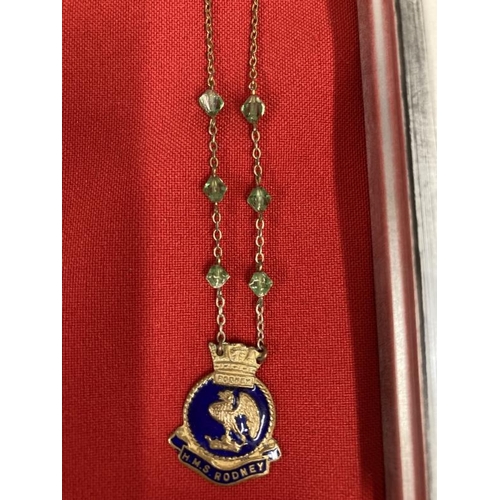 196 - Militaria/Royal Navy: H.M.S. Rodney sweetheart pendant, Vesta case and good luck horseshoe, framed. ... 