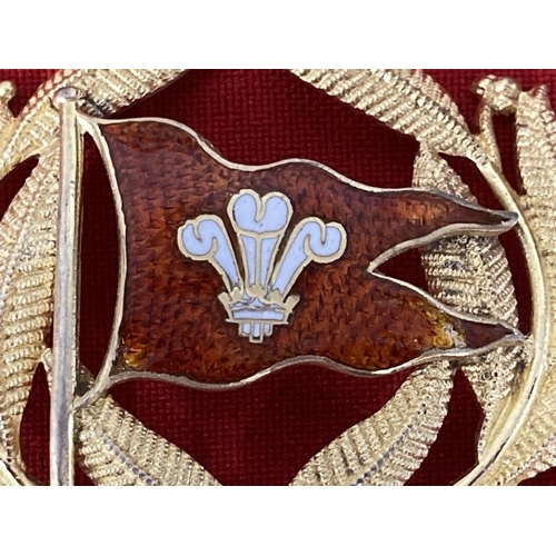 200 - Badges: Gaunt of London gilt cap badge inset with red enamel and Prince of Wales feathers, possibly ... 